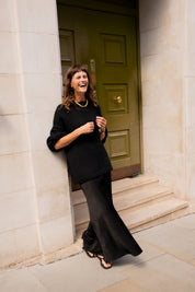 Full length fit of black oversized cotton jumper on model