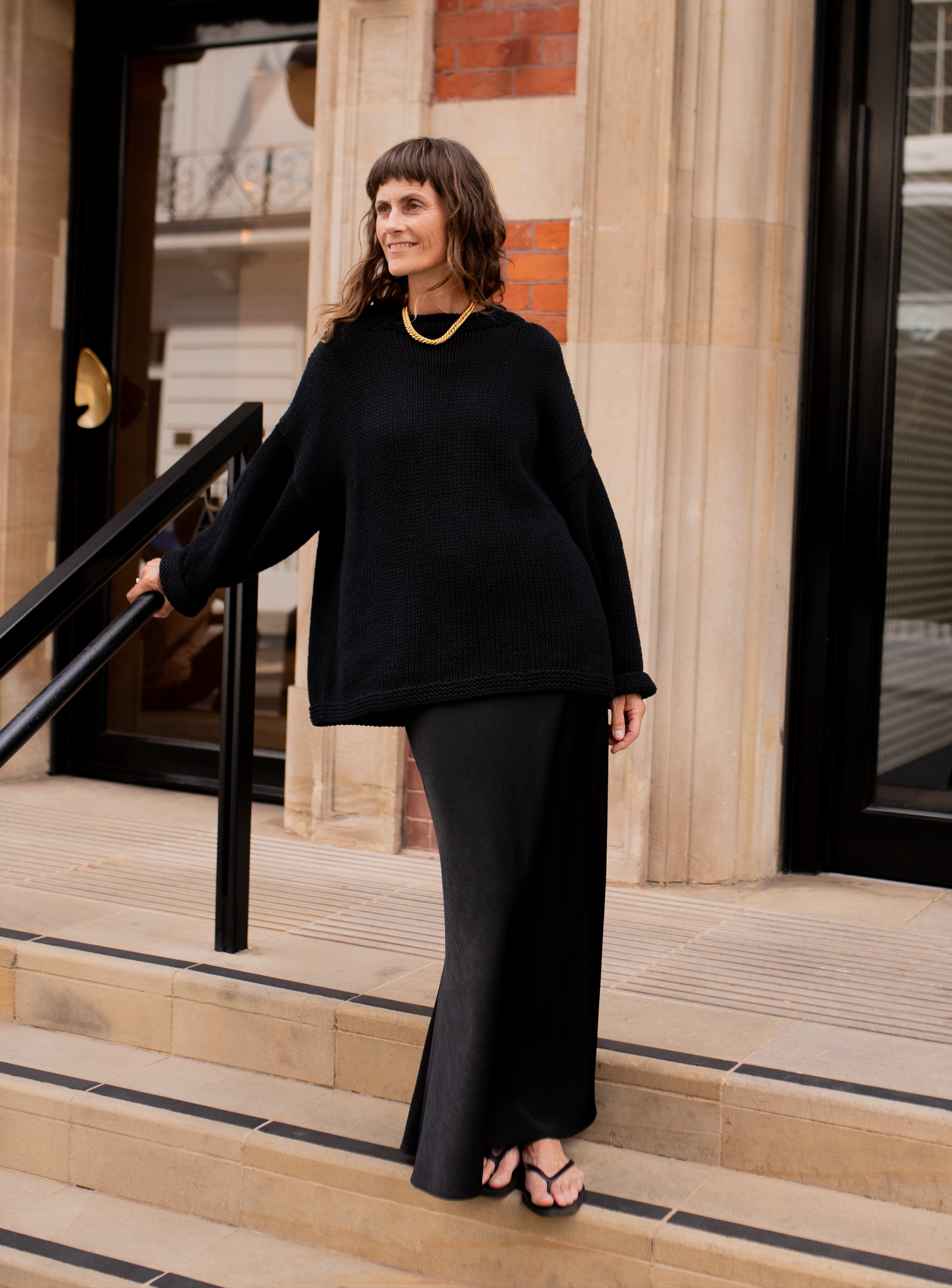 Lifestyle image of black hand knit jumper styled casually