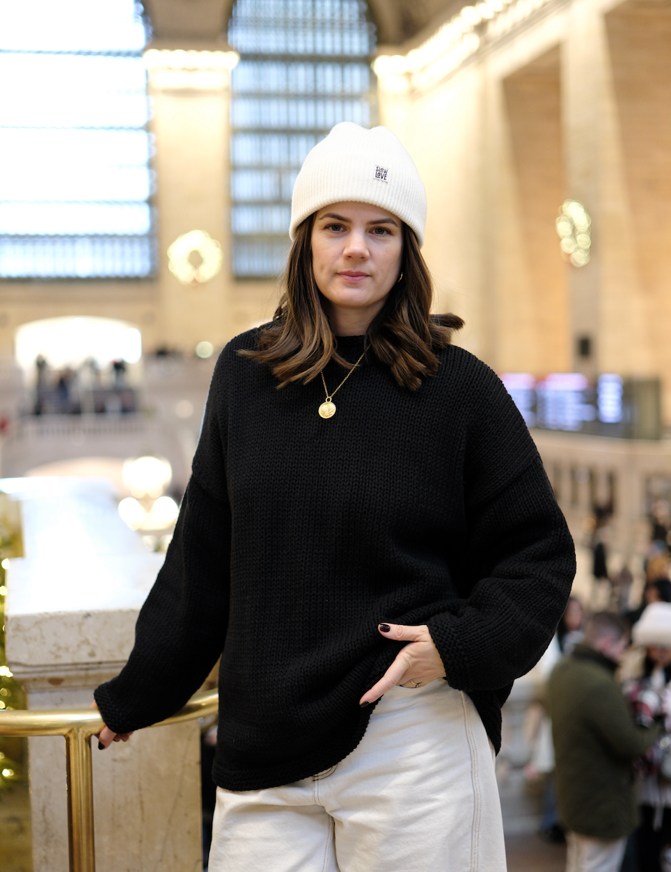 Model wearing black hand knit jumper styled from the front