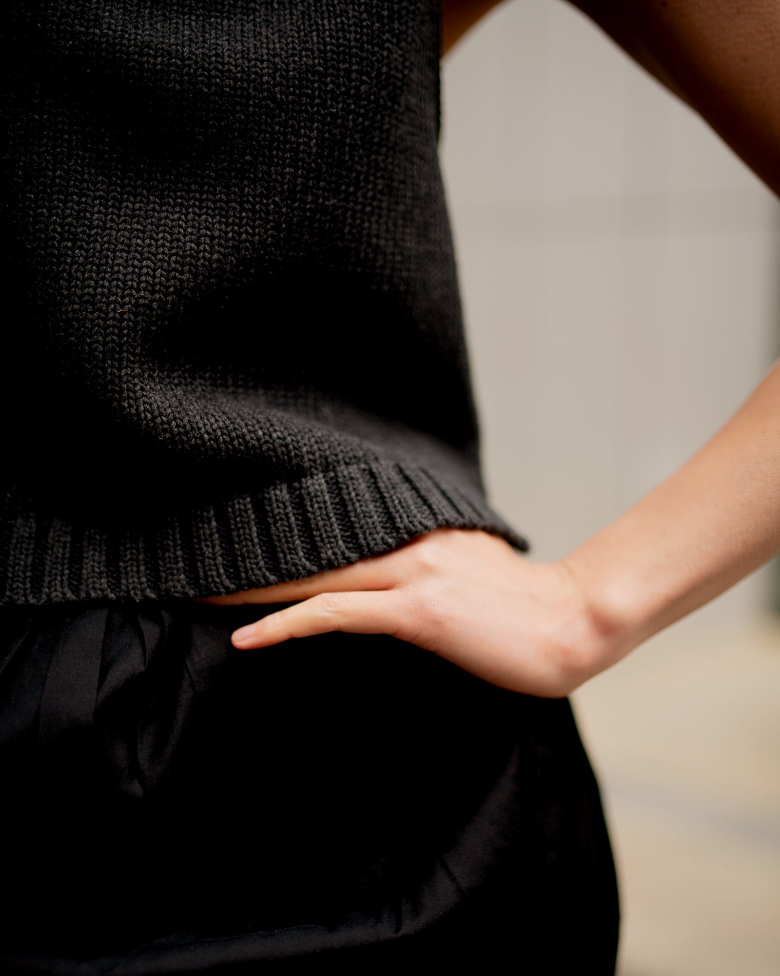 The Slow Love charcoal Staple Tank in a chunky cotton knit, styled as a versatile summer layering piece with a relaxed, sleeveless fit.