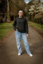 Model wearing the relaxed Charcoal Staple Crew Jumper by Slow Love Knitwear