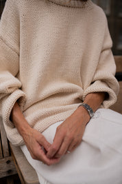 Sleeve detail of chunky cream hand knit jumper