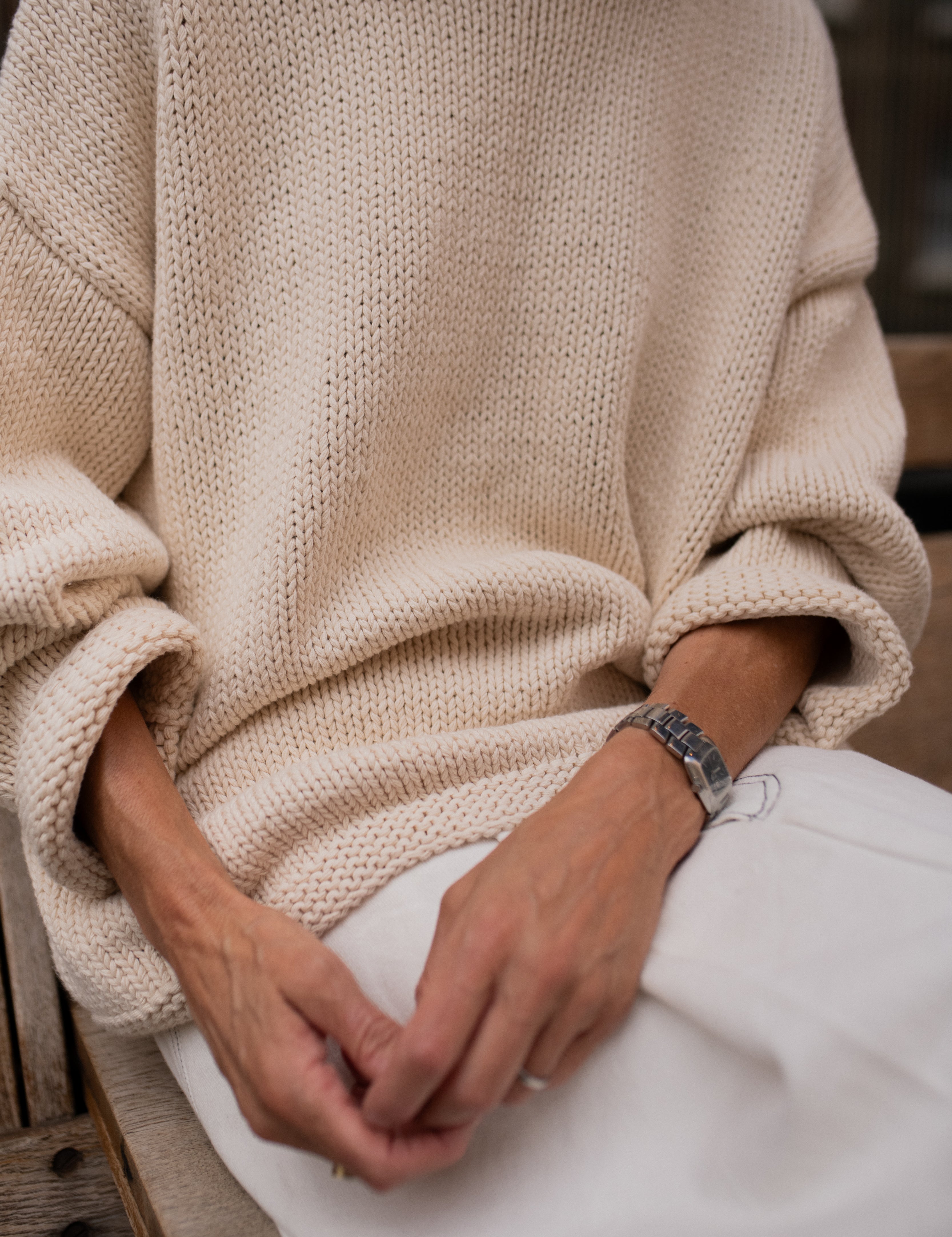 Sleeve detail of chunky cream hand knit jumper