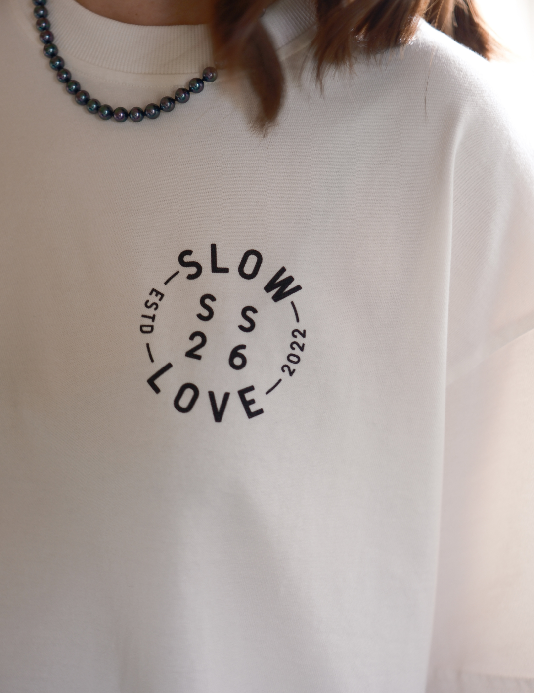 Close-up detail of the Compass graphic on an off white heavyweight organic cotton t-shirt.