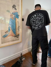 Model wearing the Compass faded black oversized boxy t-shirt with a relaxed silhouette.