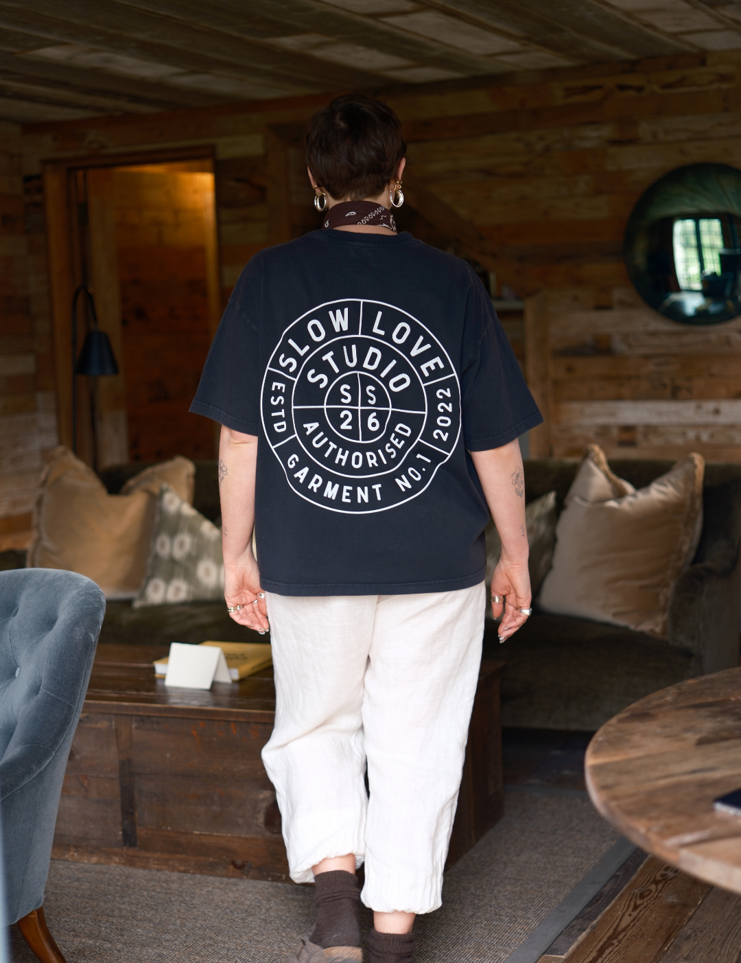 Model wearing the Compass faded black oversized boxy t-shirt with a relaxed silhouette.