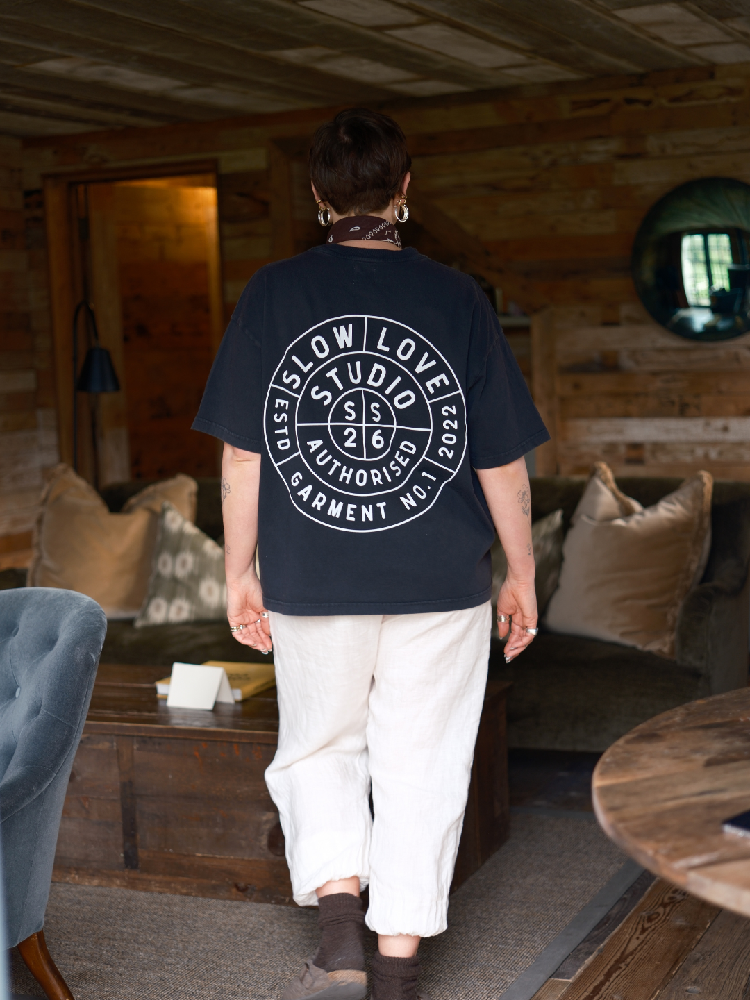 Model wearing the Compass faded black oversized boxy t-shirt with a relaxed silhouette.
