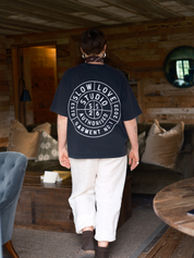 Model wearing the Compass faded black oversized boxy t-shirt with a relaxed silhouette.