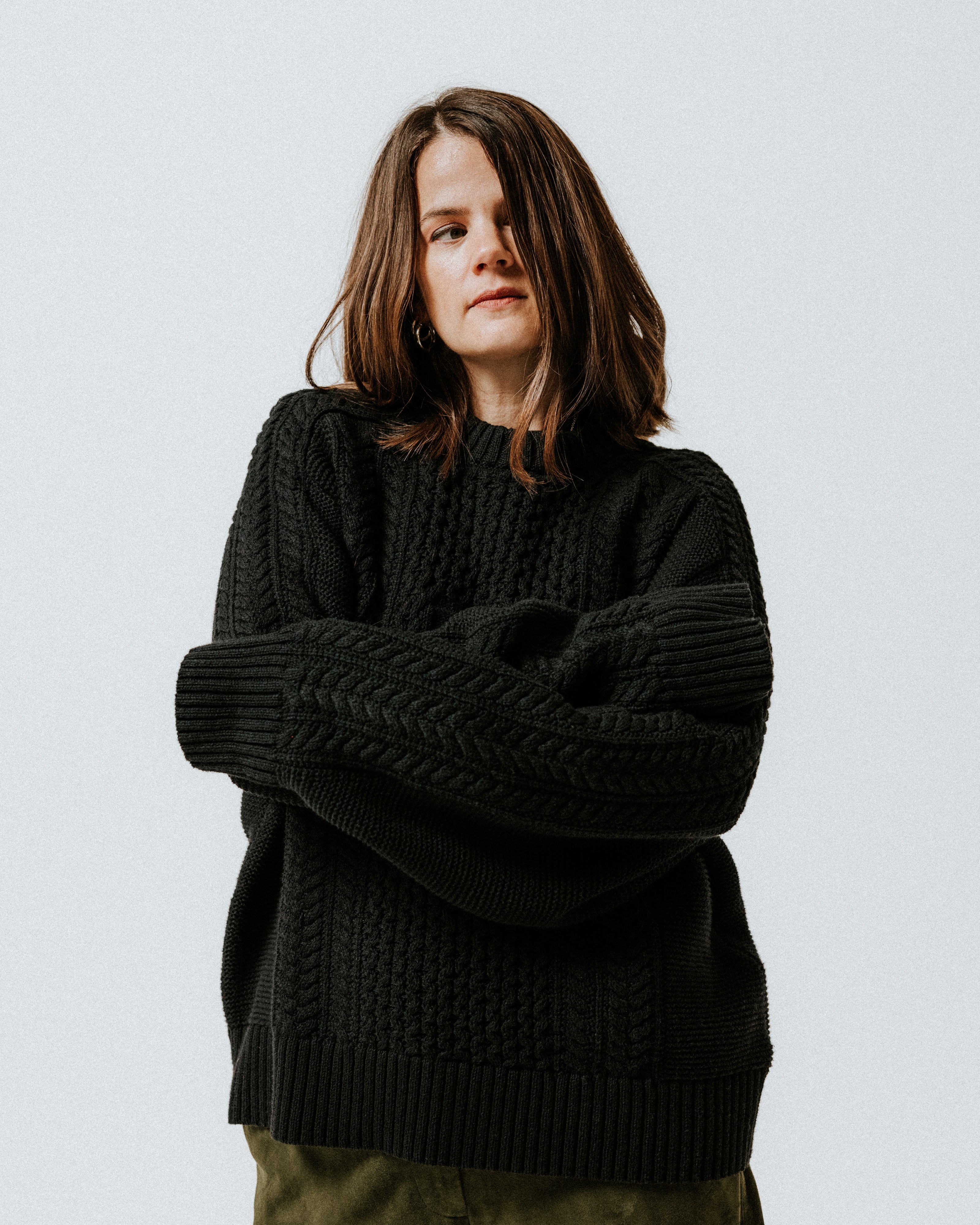 Model wearing the black 100% cotton Aran Jumper by Slow Love Knitwear
