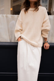 Lifestyle image of cream hand knit jumper styled casually