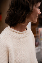 Close-up of cream cotton knit texture showing stitch detail