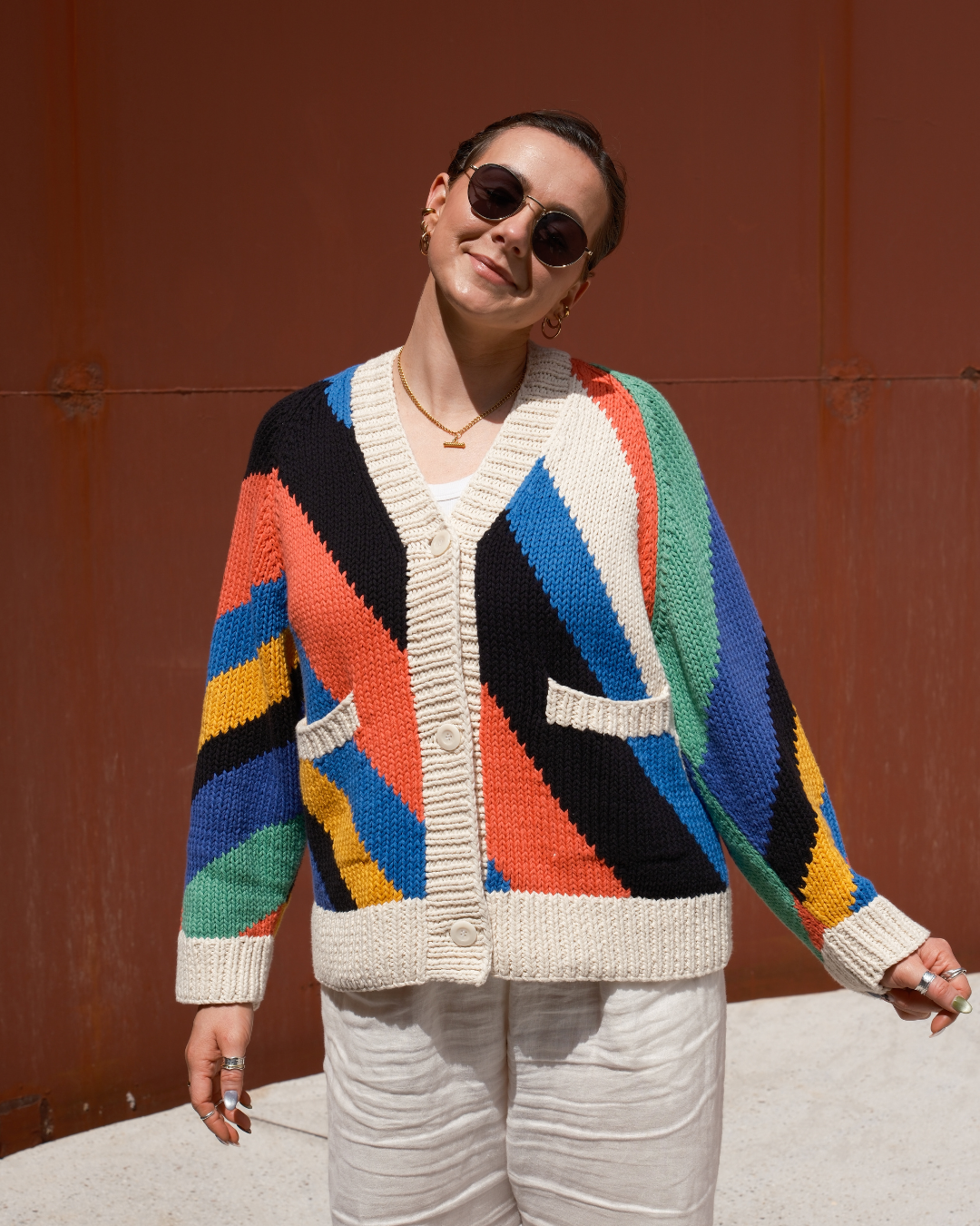 Oversized hand knit cotton cardigan with seven colour diagonal intarsia stripe pattern