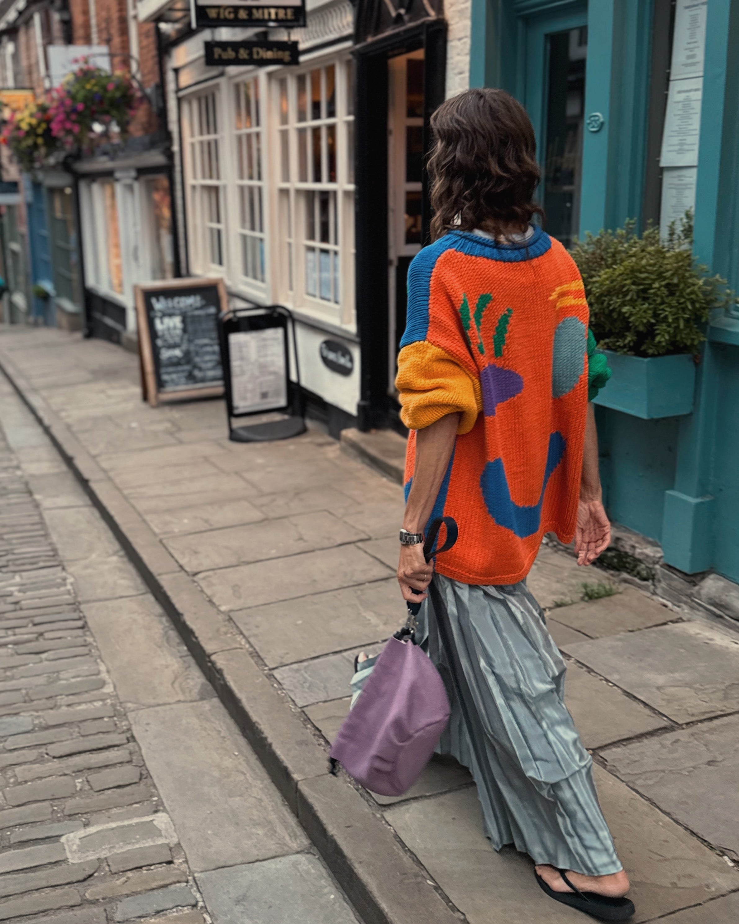 Back view of oversized multicoloured hand knitted cotton jumper