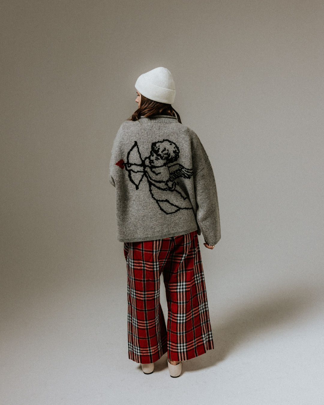 Grey wool Cherub Jumper by Slow Love featuring its distinctive graphic motif and timeless knitted construction.