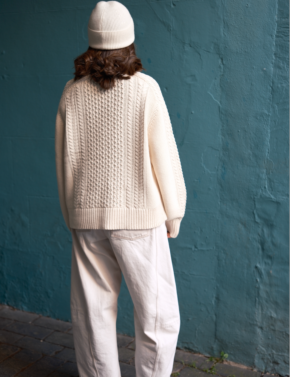 Back of model wearing the Oat Milk 100% cotton Aran Jumper by Slow Love Knitwear