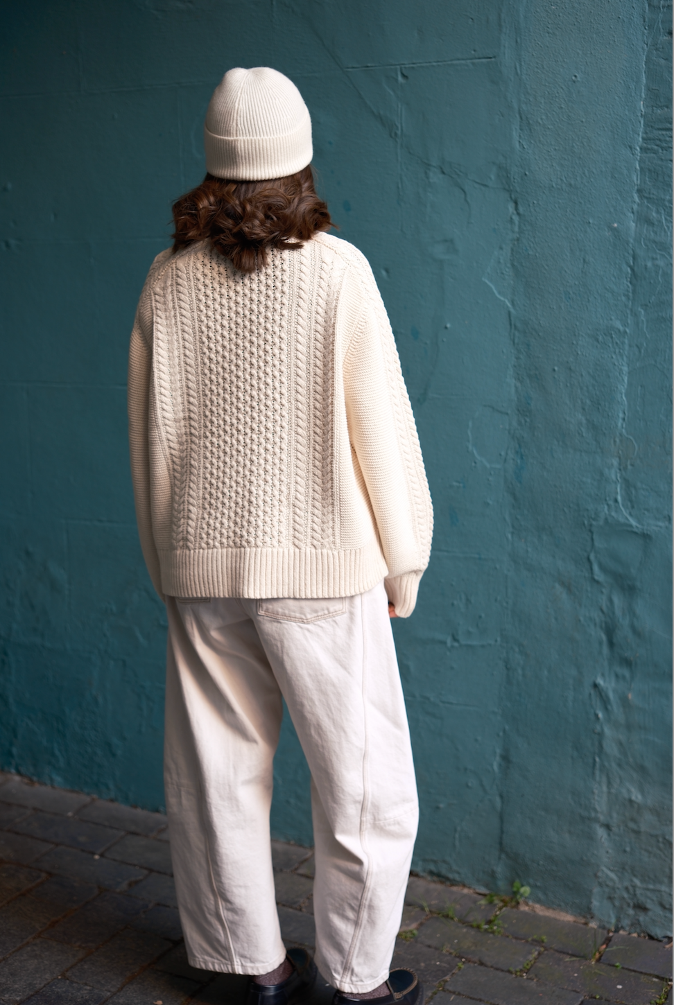 Back of model wearing the Oat Milk 100% cotton Aran Jumper by Slow Love Knitwear