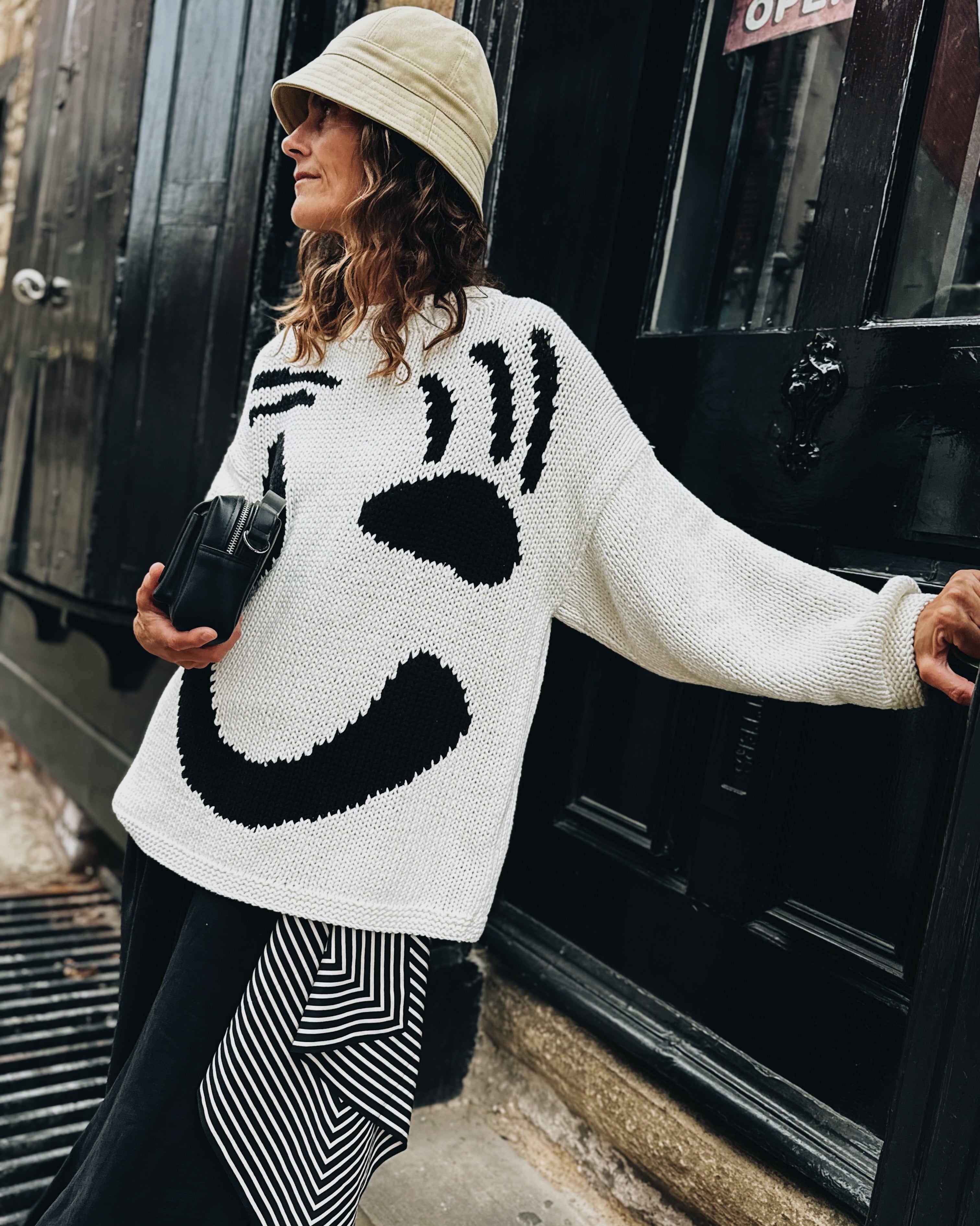 Side profile of oversized black and white cotton jumper with boxy fit