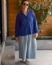 Women’s oversized 100% cotton cardigan featuring a large smiley face graphic on the back