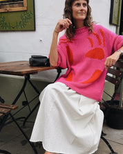 Full length view of oversized pink and red cotton jumper on model
