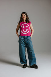 Close-up of smiley face detail on pink and white cotton knit tank top