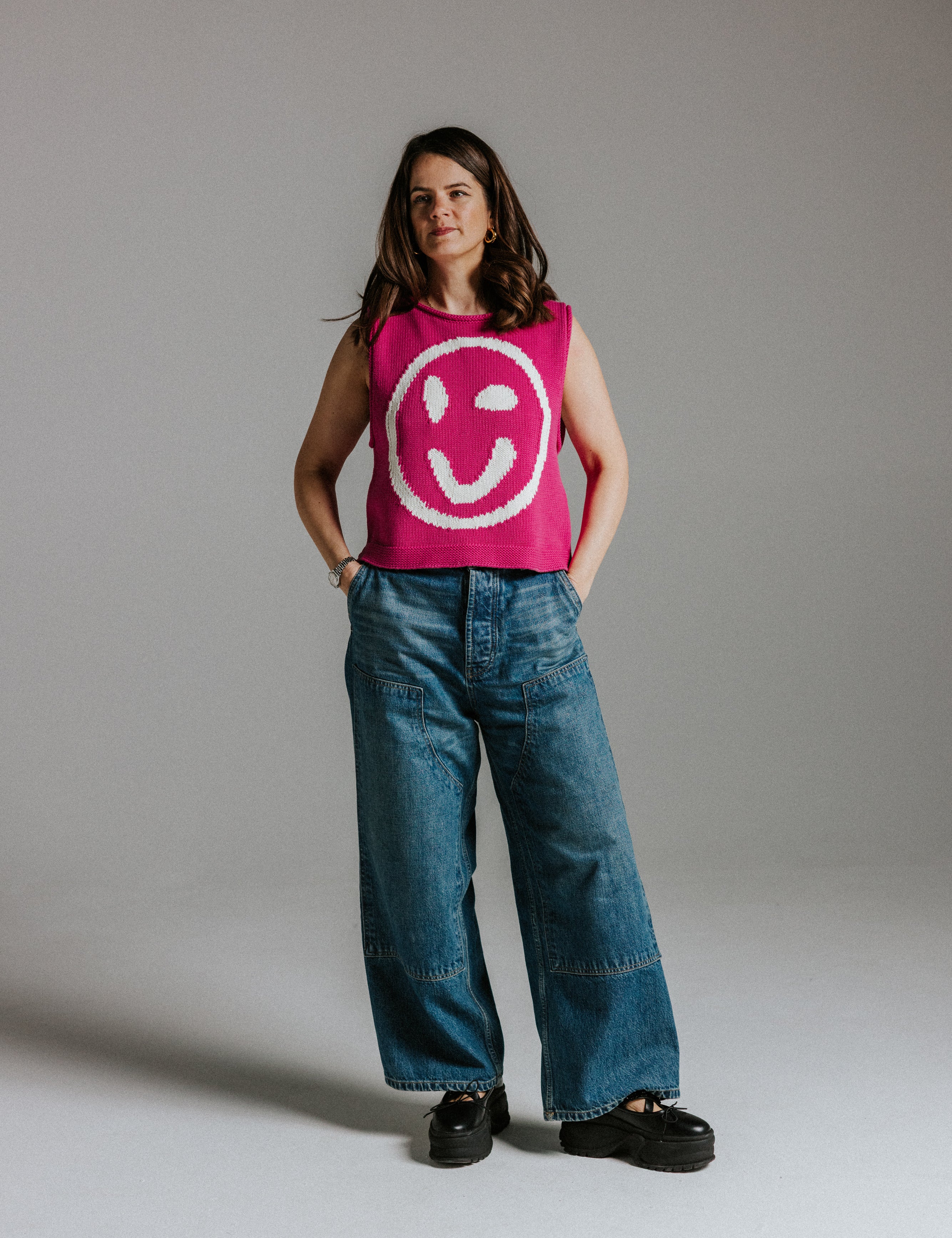 Close-up of smiley face detail on pink and white cotton knit tank top