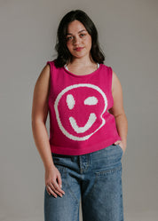 Pink and white smiley face knit tank top styled with jeans for a casual summer outfit