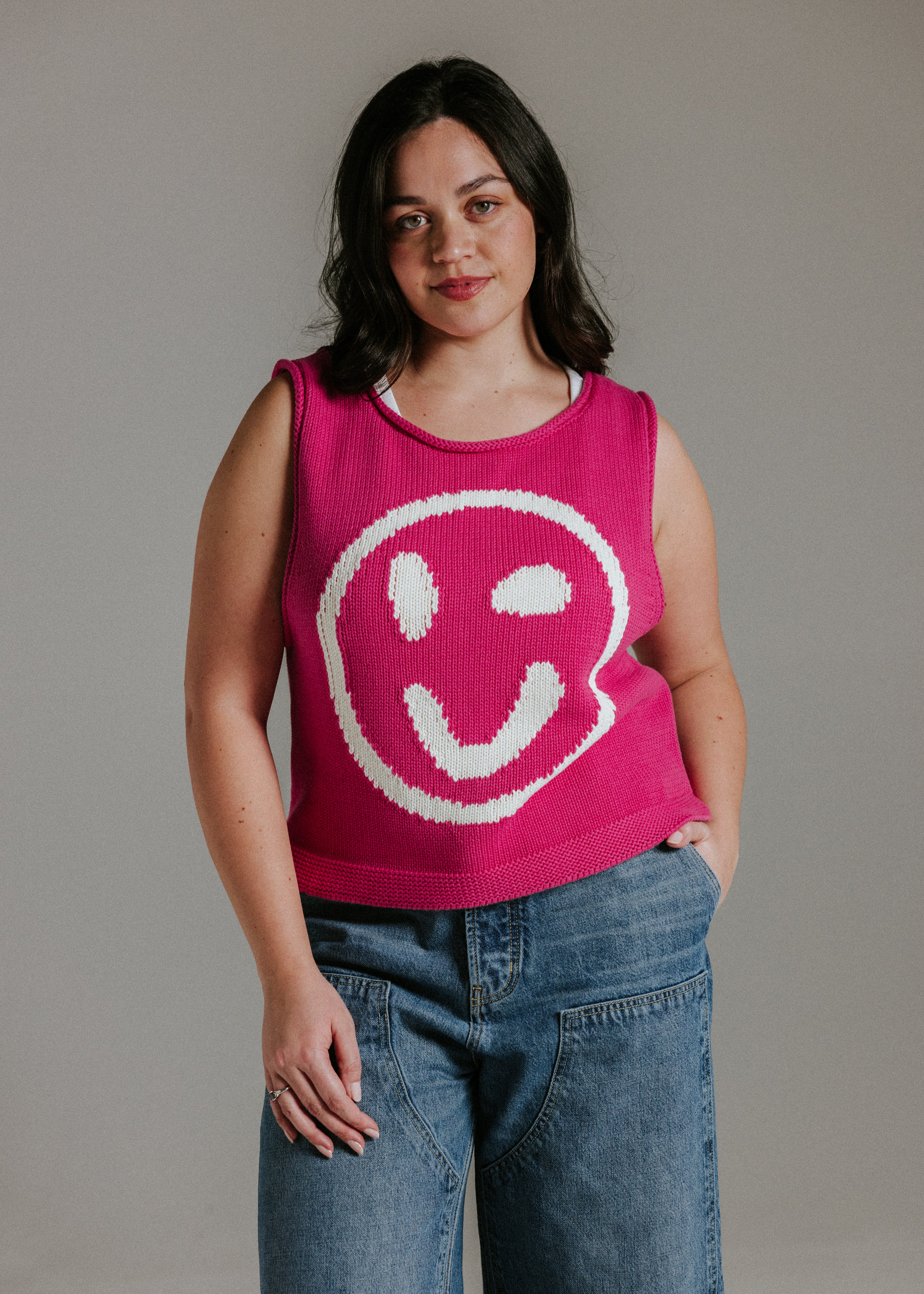 Pink and white smiley face knit tank top styled with jeans for a casual summer outfit