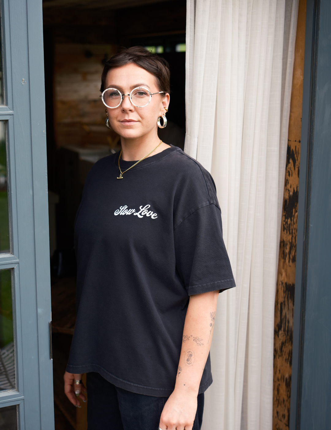 Model wearing the SL Script faded black oversized boxy t-shirt with a relaxed silhouette.