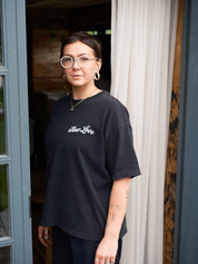 Model wearing the SL Script faded black oversized boxy t-shirt with a relaxed silhouette.