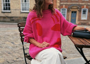 Lifestyle image of pink and red hand knit jumper in slow fashion styling