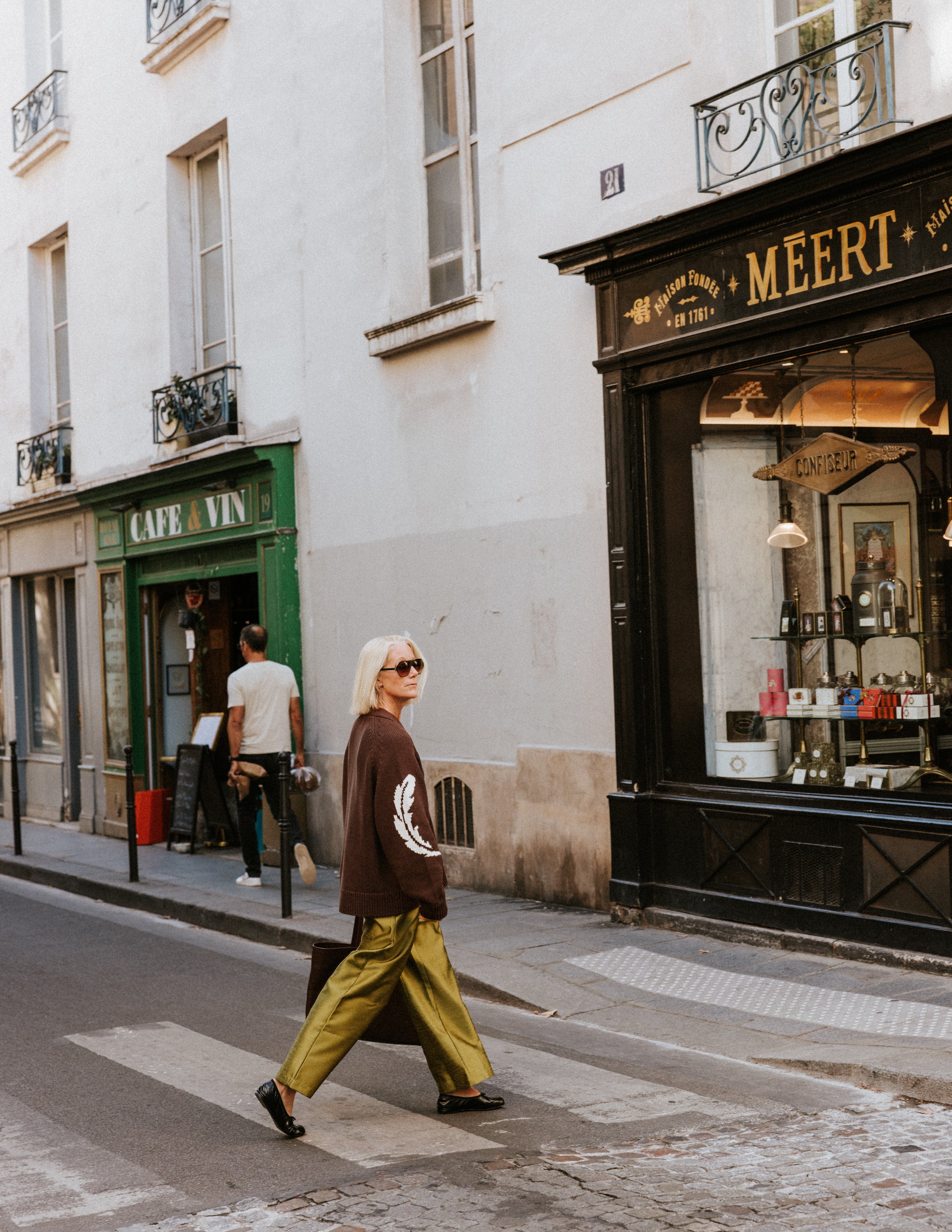 Shot of the Slow Love Feather Cardigan, highlighting its distinctive feather detailing and textured knit.