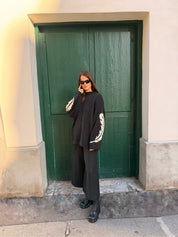 Styling the Slow Love Feather Hand Knit Jumper featuring feather motifs along the arms and a relaxed, oversized silhouette.