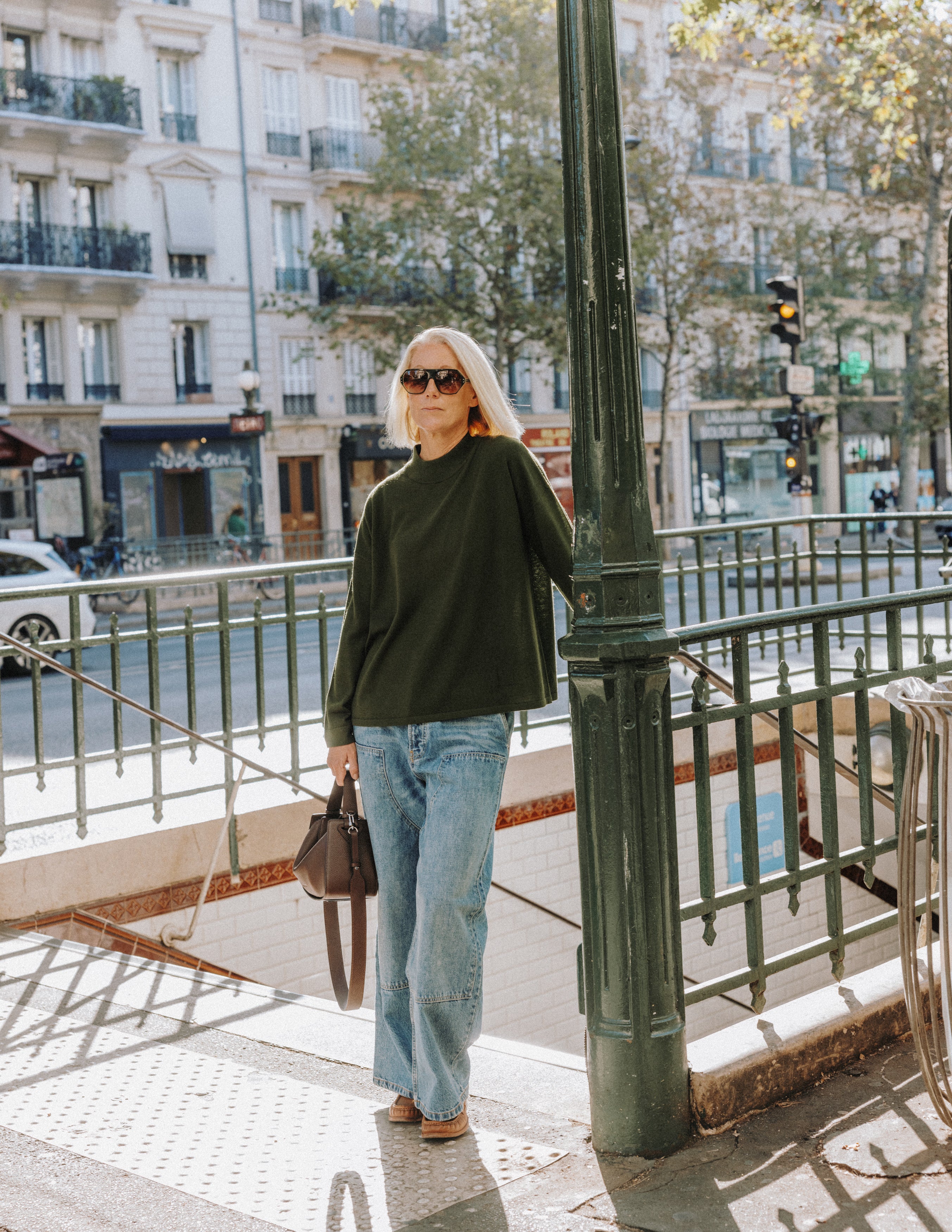 Model wearing The Slow Love khaki merino wool turtle neck jumper, showcasing its lightweight knit and classic silhouette.