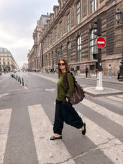 The Slow Love khaki extra fine merino wool jumper styled as a lightweight layering piece for cooler weather.