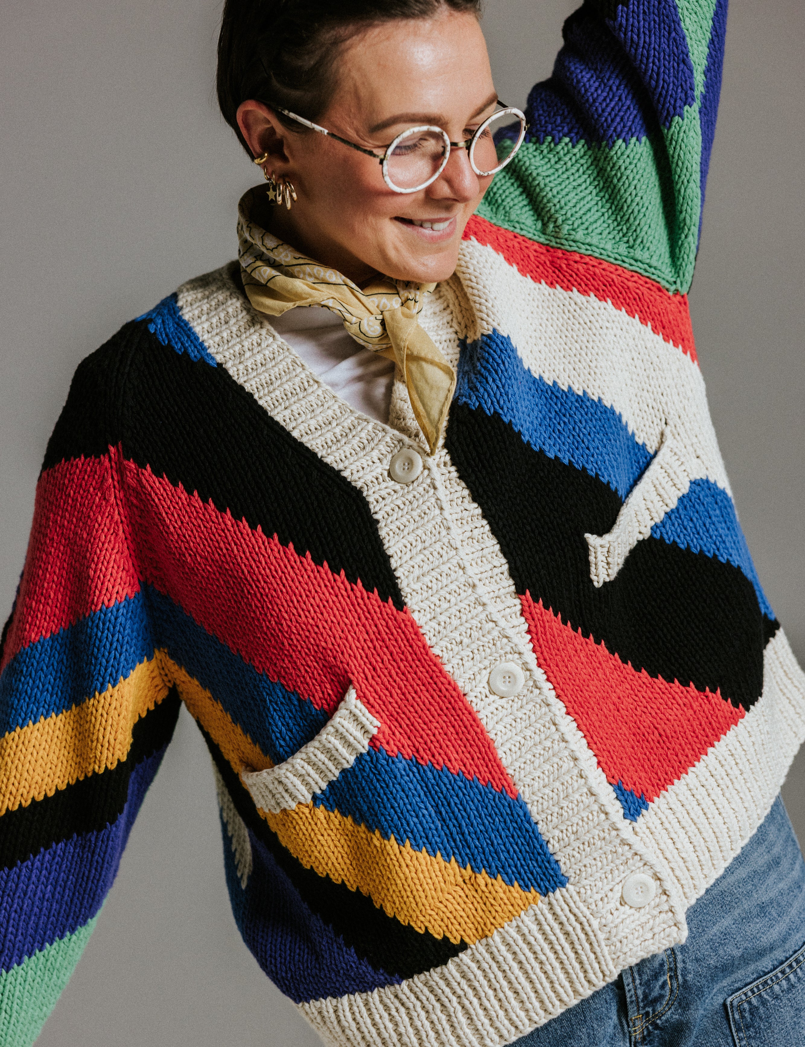 Close up of seven colour intarsia stripe pattern on handknit cotton cardigan by Slow Love Knitwear