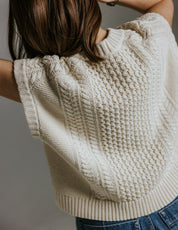 Model wearing boxy cotton knit tank top inspired by Aran jumper by Slow Love Knitwear styled for summer 