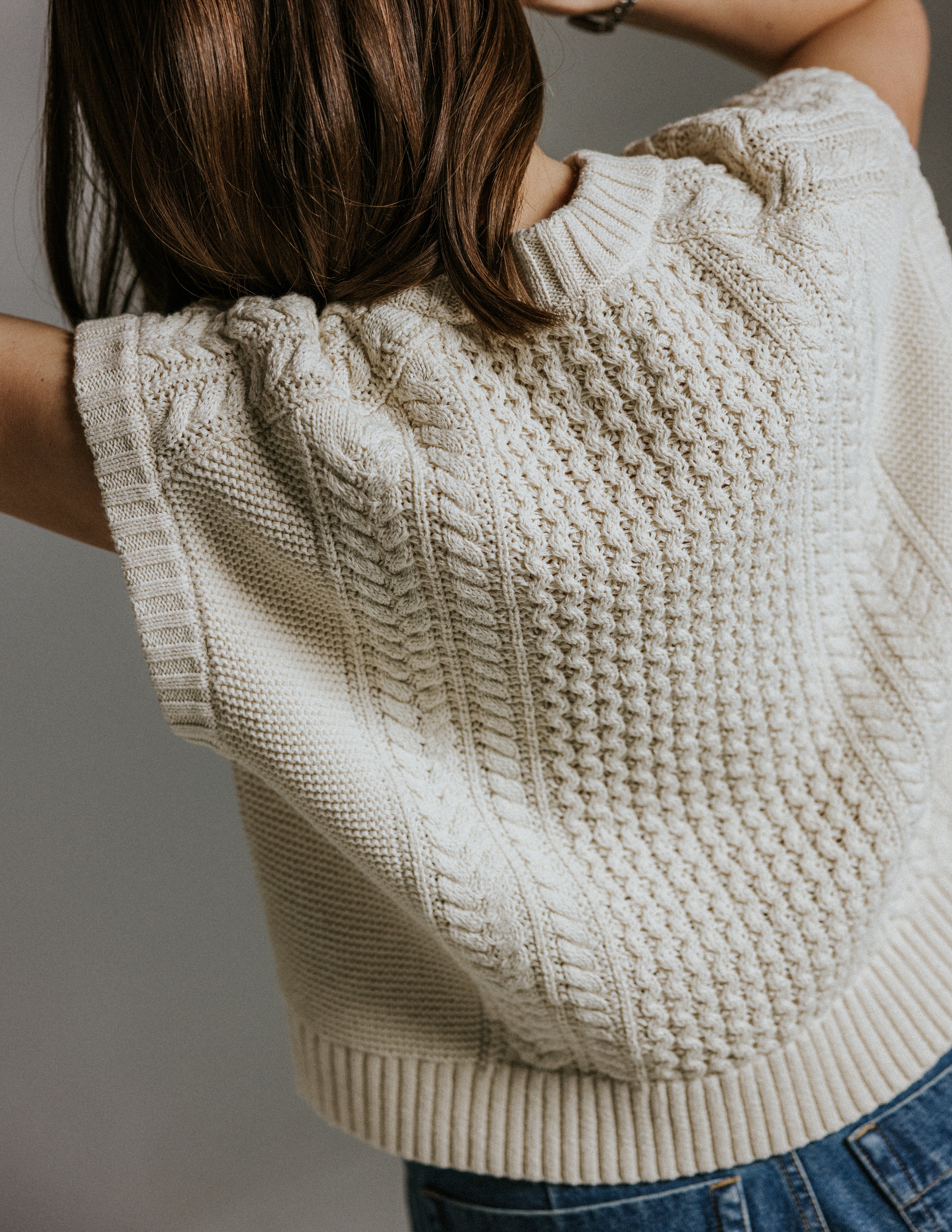 Model wearing boxy cotton knit tank top inspired by Aran jumper by Slow Love Knitwear styled for summer 