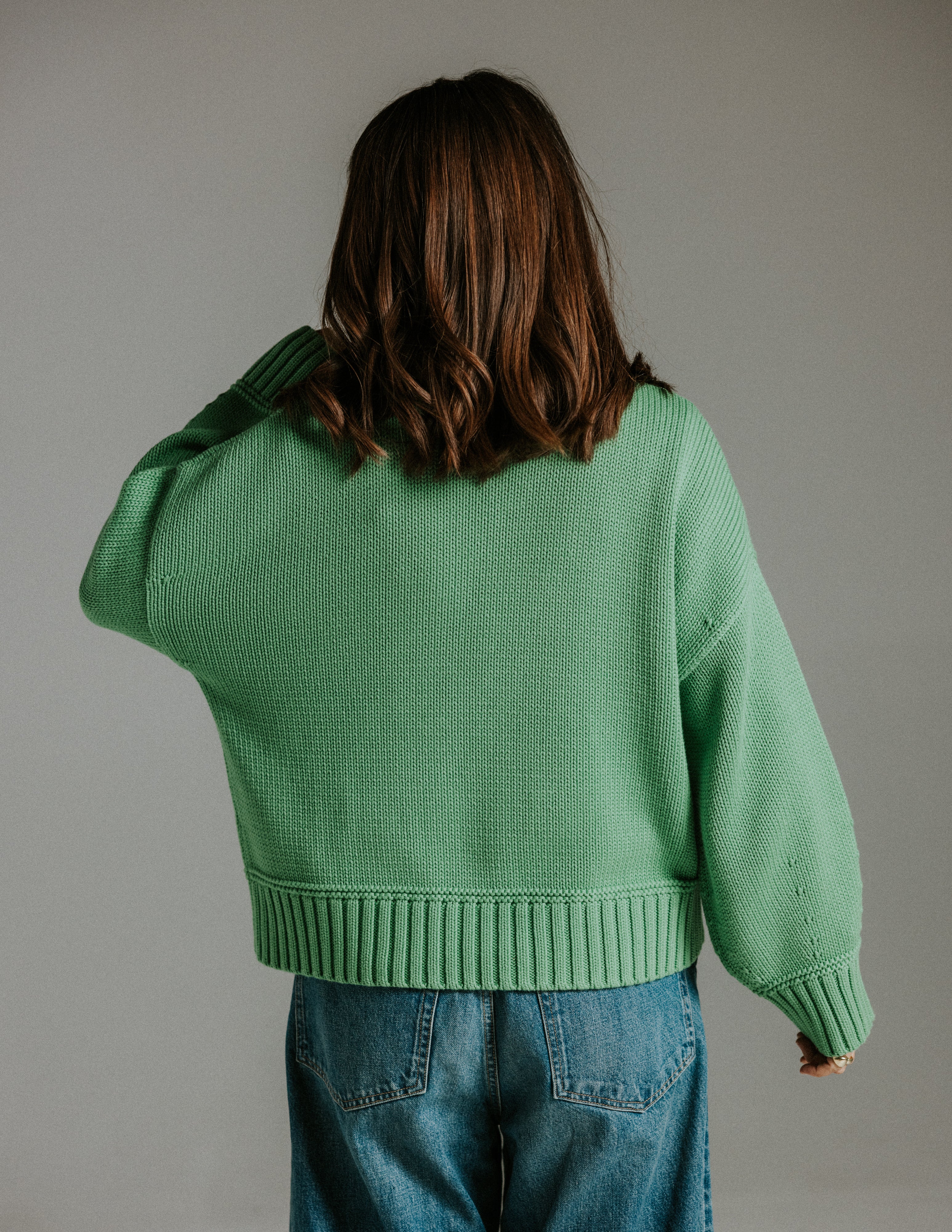 Back view of boxy 100 percent cotton knit green jumper with relaxed fit by Slow Love Knitwear