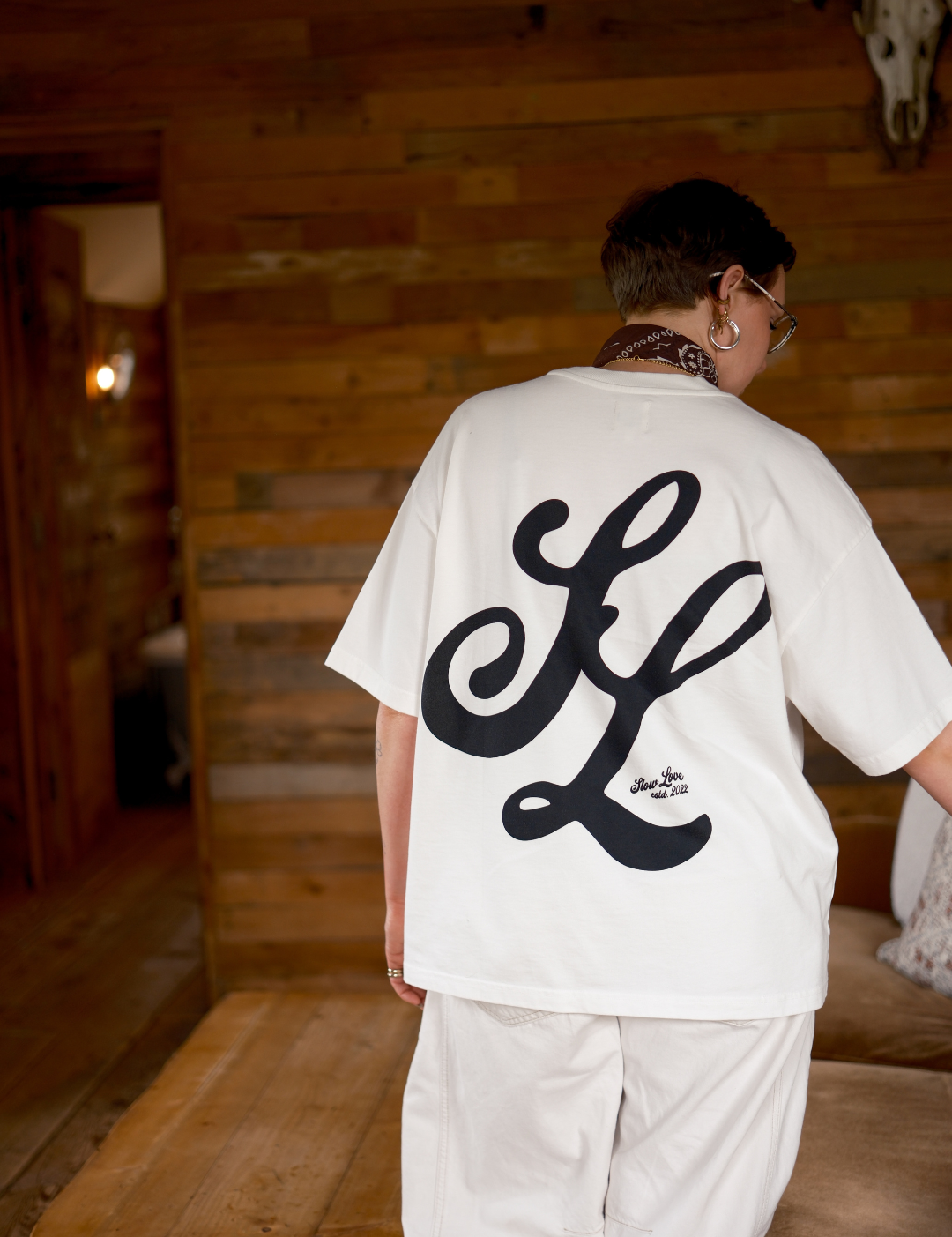 Back view of the Slow Love Script oversized boxy t-shirt in off white organic cotton.