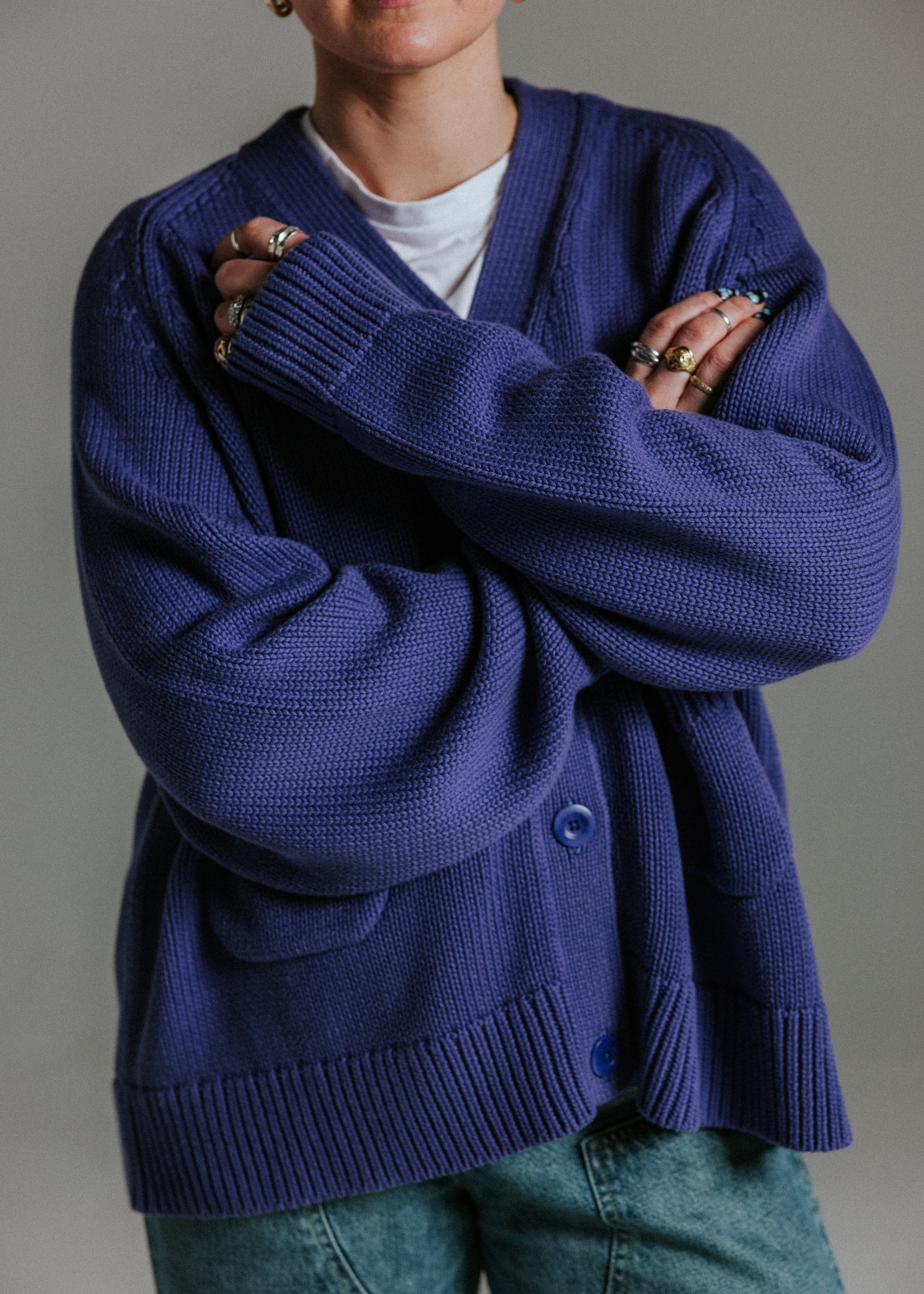 Detail of oversized cotton knit cardigan by Slow Love Knitwear in faded indigo and white