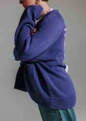 Side of oversized cotton knit cardigan by Slow Love Knitwear in faded indigo and white