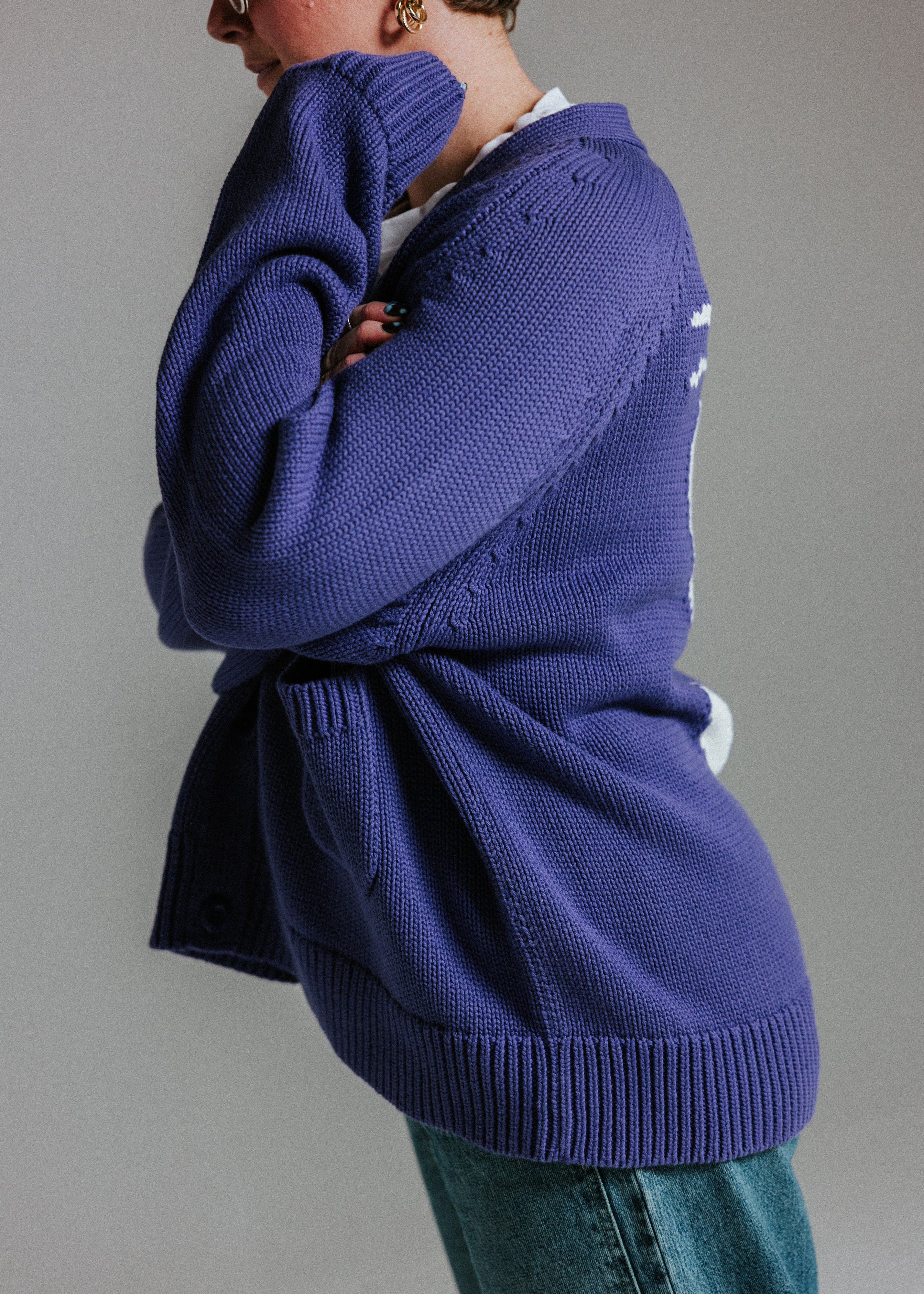 Side of oversized cotton knit cardigan by Slow Love Knitwear in faded indigo and white