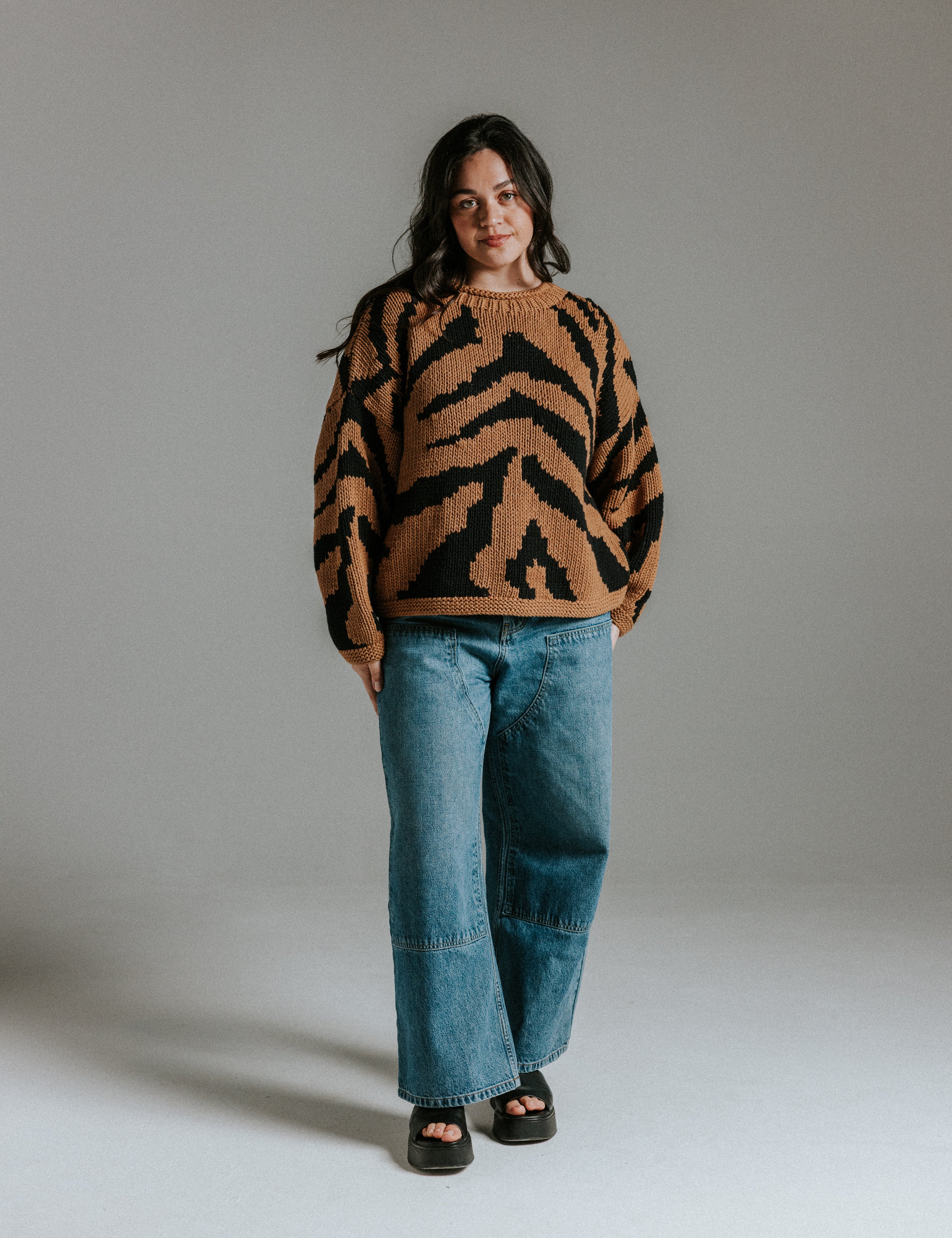 Model wearing cropped hand knitted cotton jumper with intarsia tiger pattern by Slow Love Knitwear