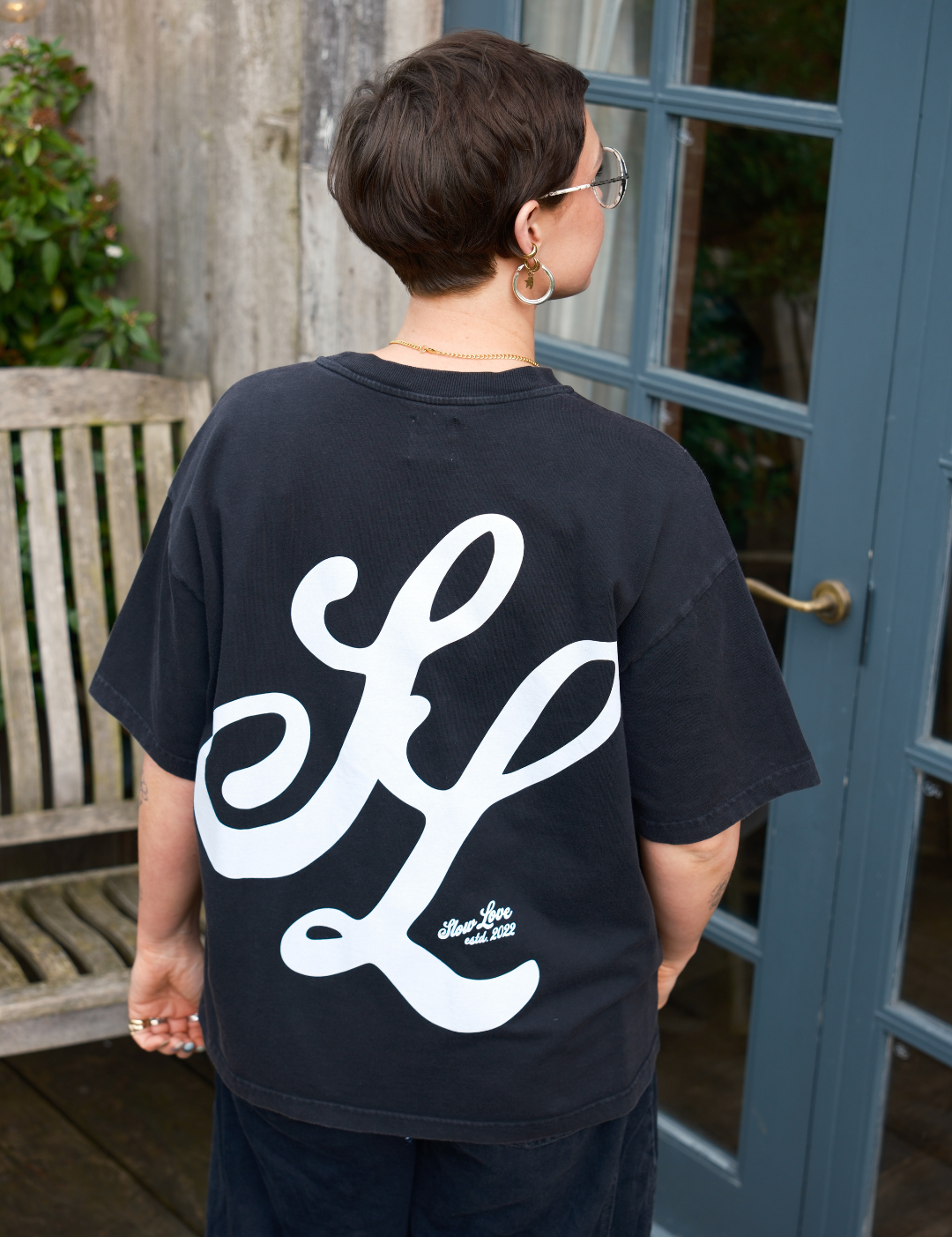 Back view of the SL Script oversized boxy t-shirt in faded black organic cotton.