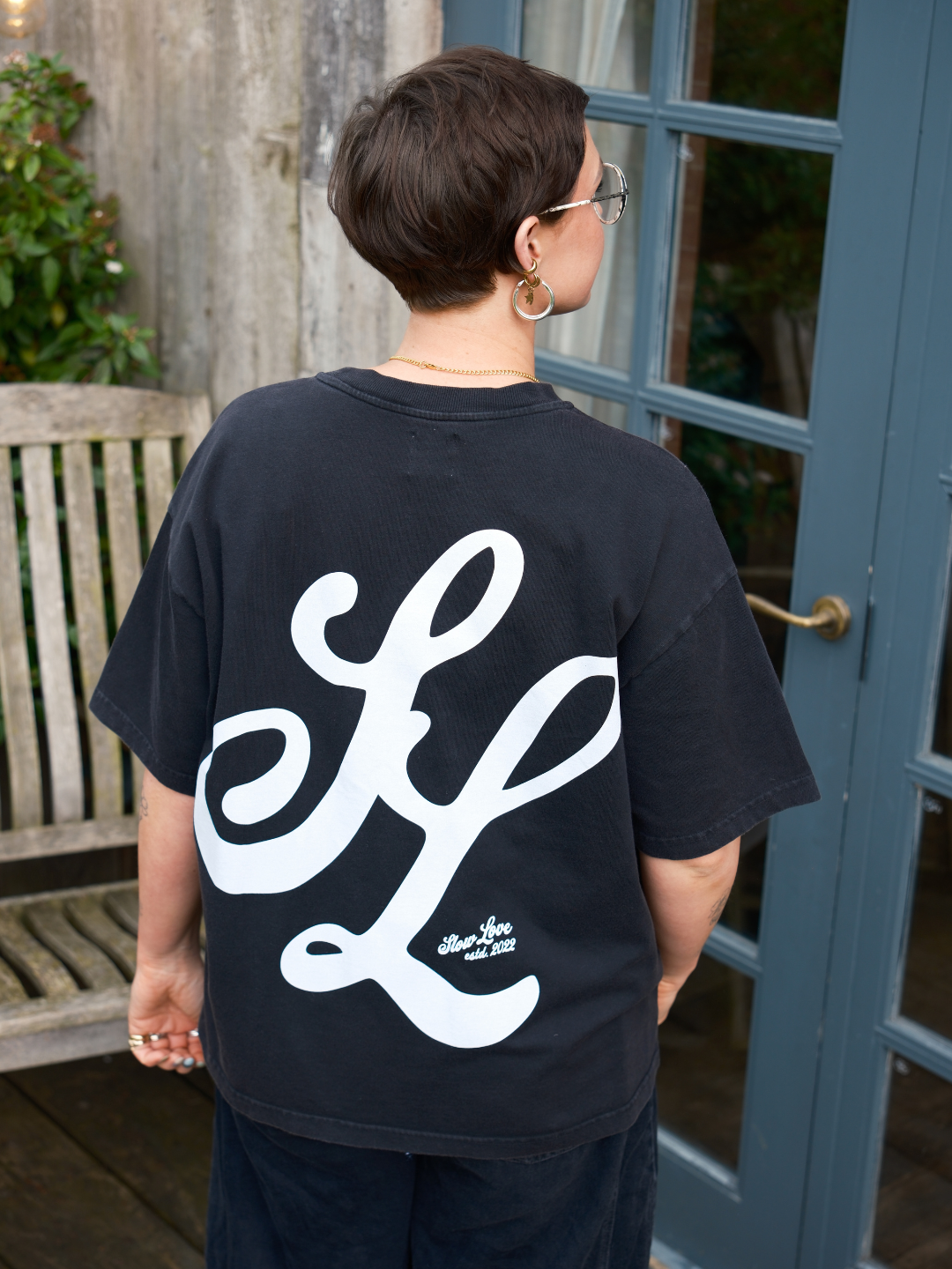Back view of the SL Script oversized boxy t-shirt in faded black organic cotton.