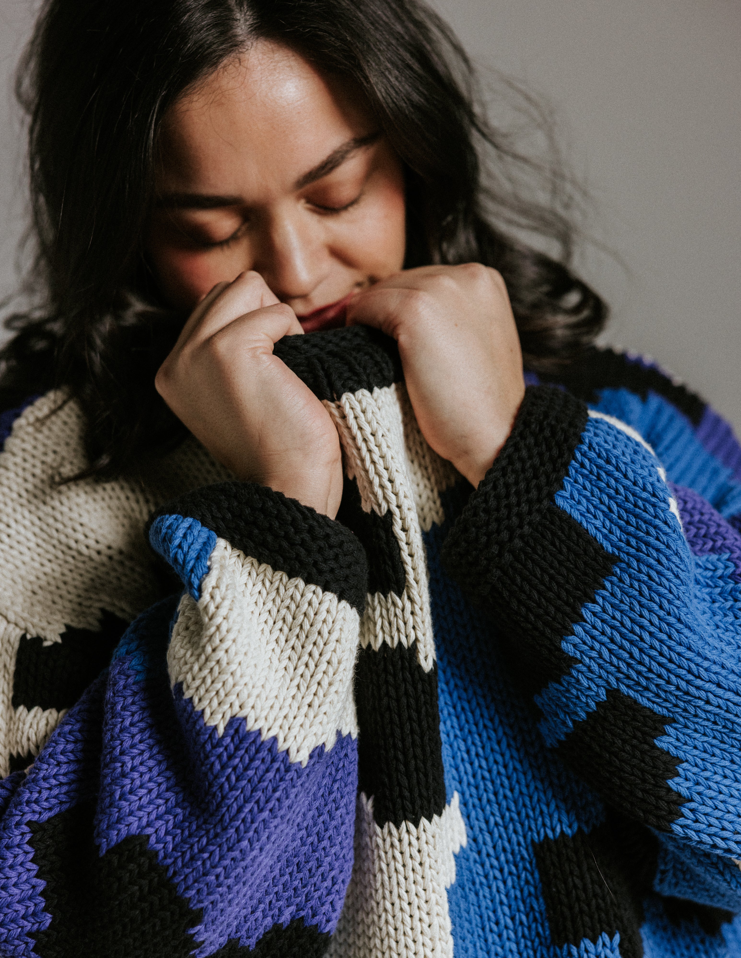 Close up of 100 percent cotton hand knitted jumper texture and floral pattern by Slow Love Knitwear