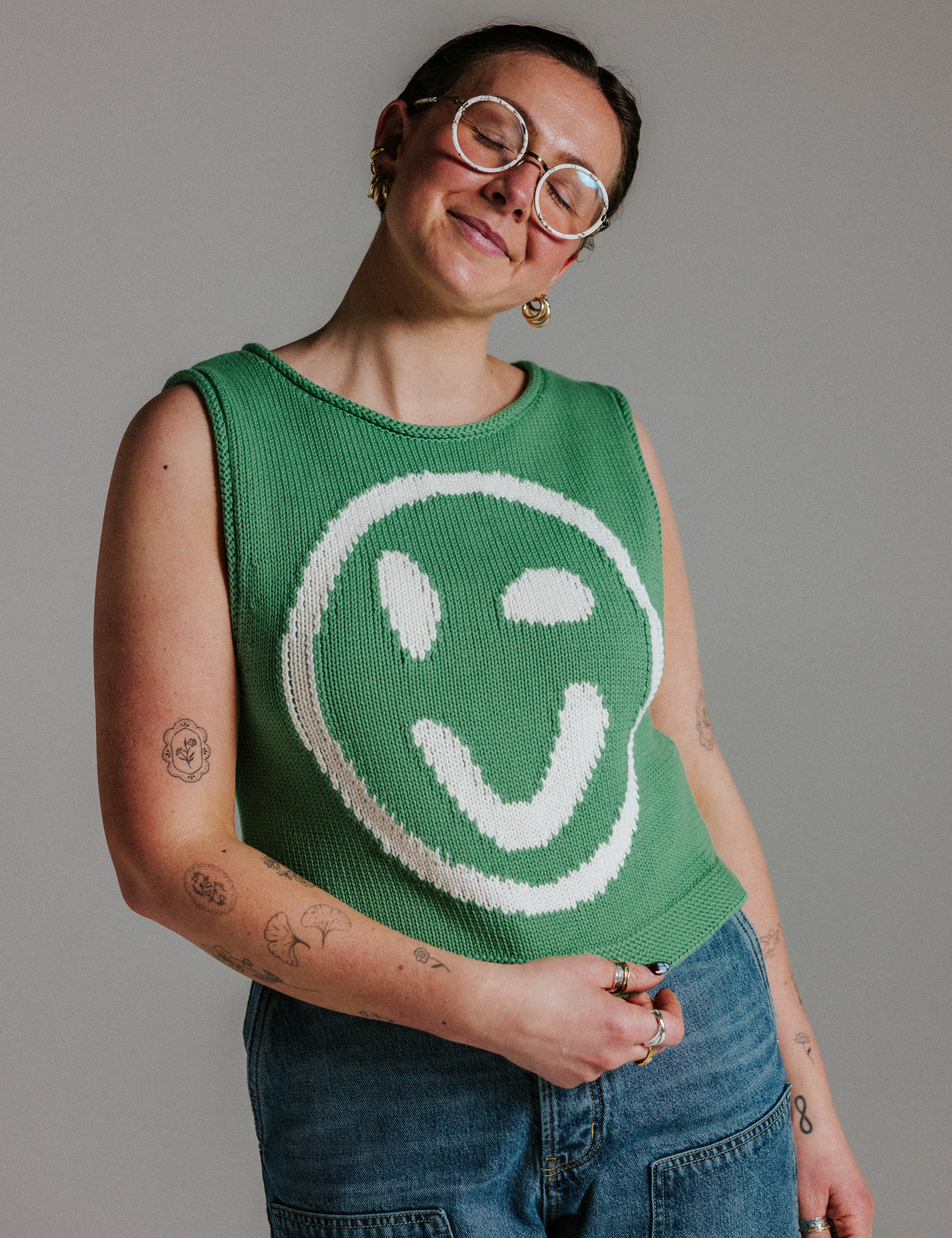 Green and white cotton knit tank top by Slow Love Knitwear with smiley face motif and boxy fit