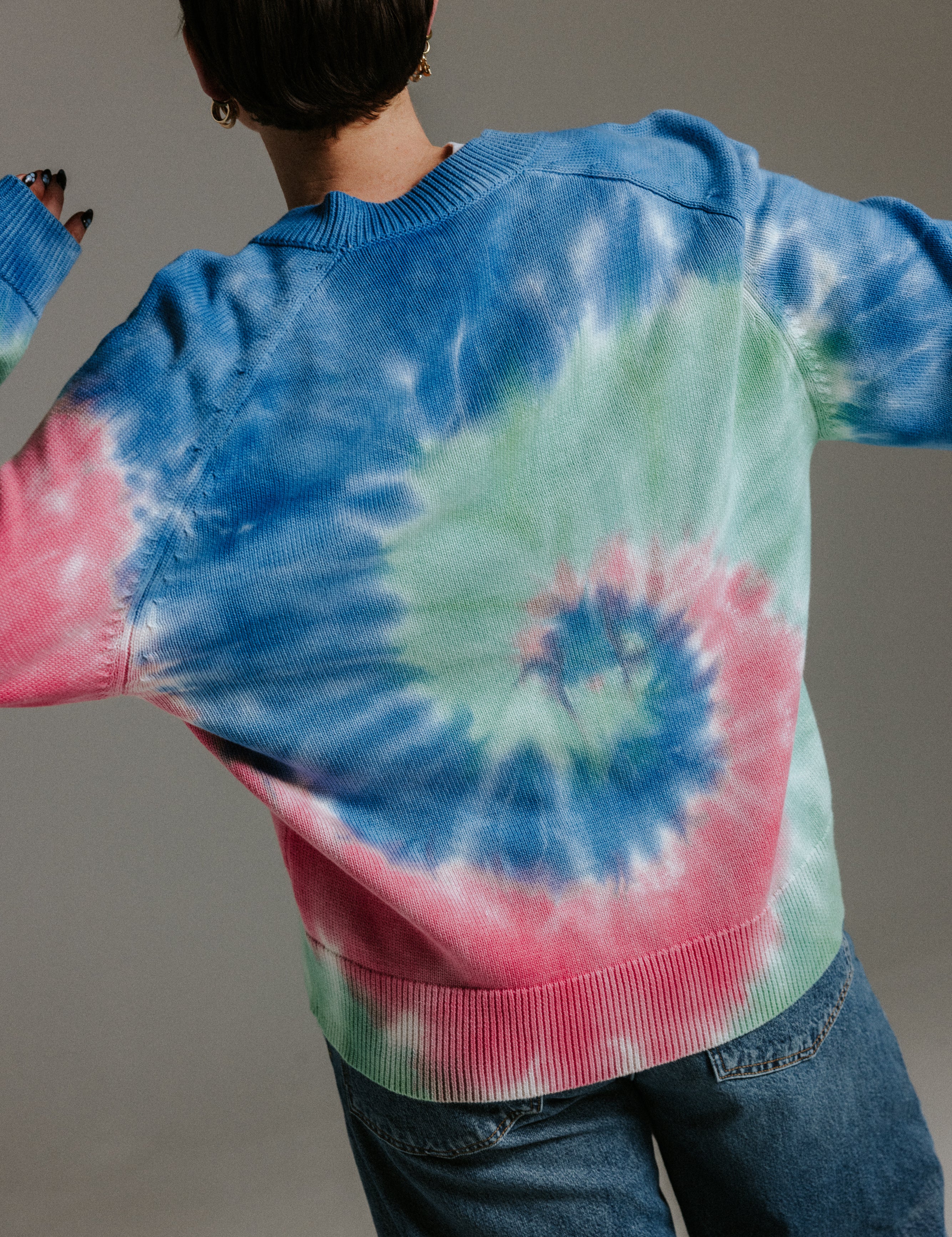 Back view of hand tie-dyed cotton cardigan by Slow Love Knitwear with unique sun-washed colour pattern