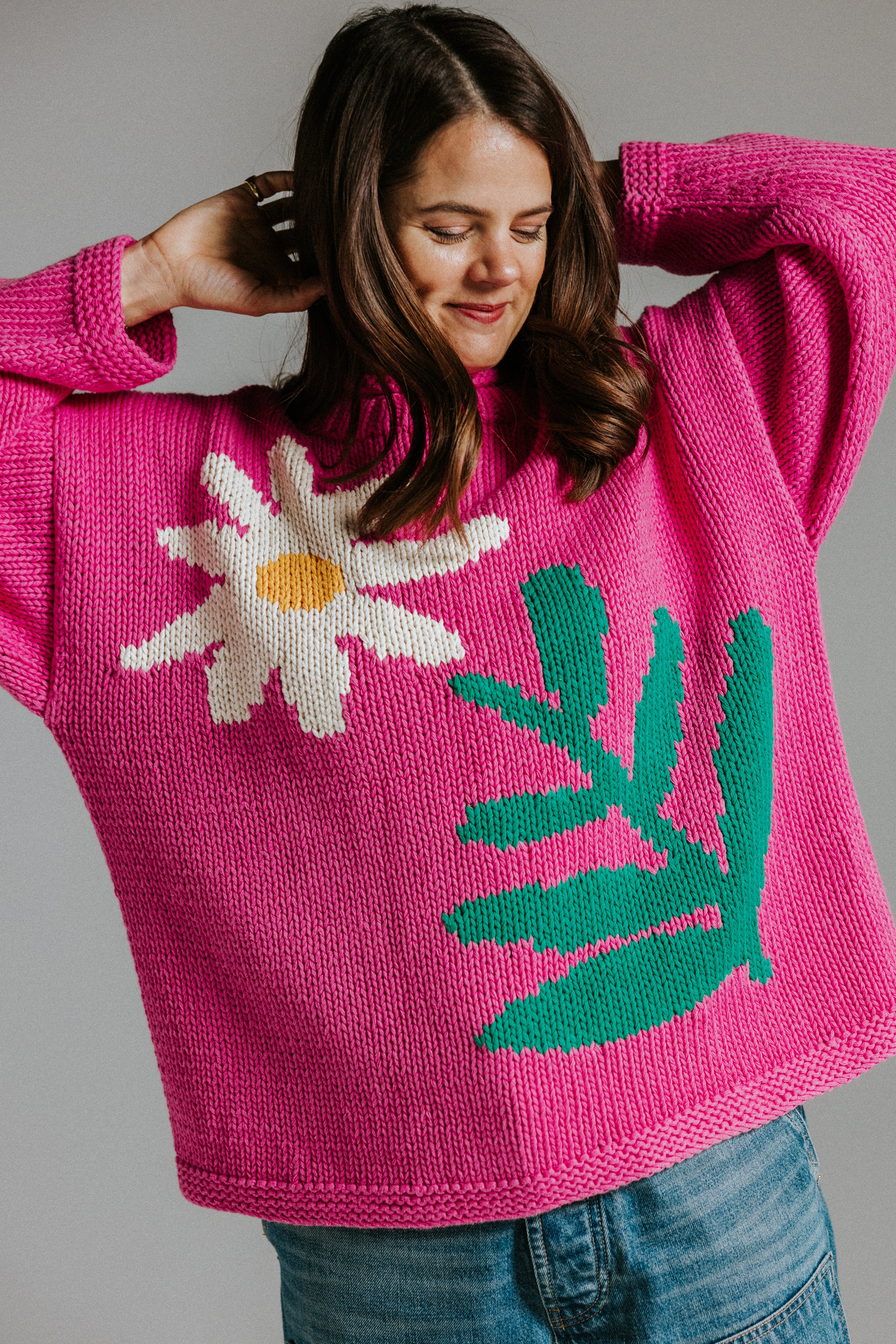 Hand knitted cotton jumper by Slow Love Knitwear with four colour intarsia daisy motif