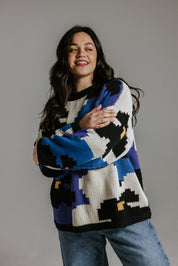 Hand knitted cotton jumper by Slow Love Knitwear with five colour floral intarsia pattern